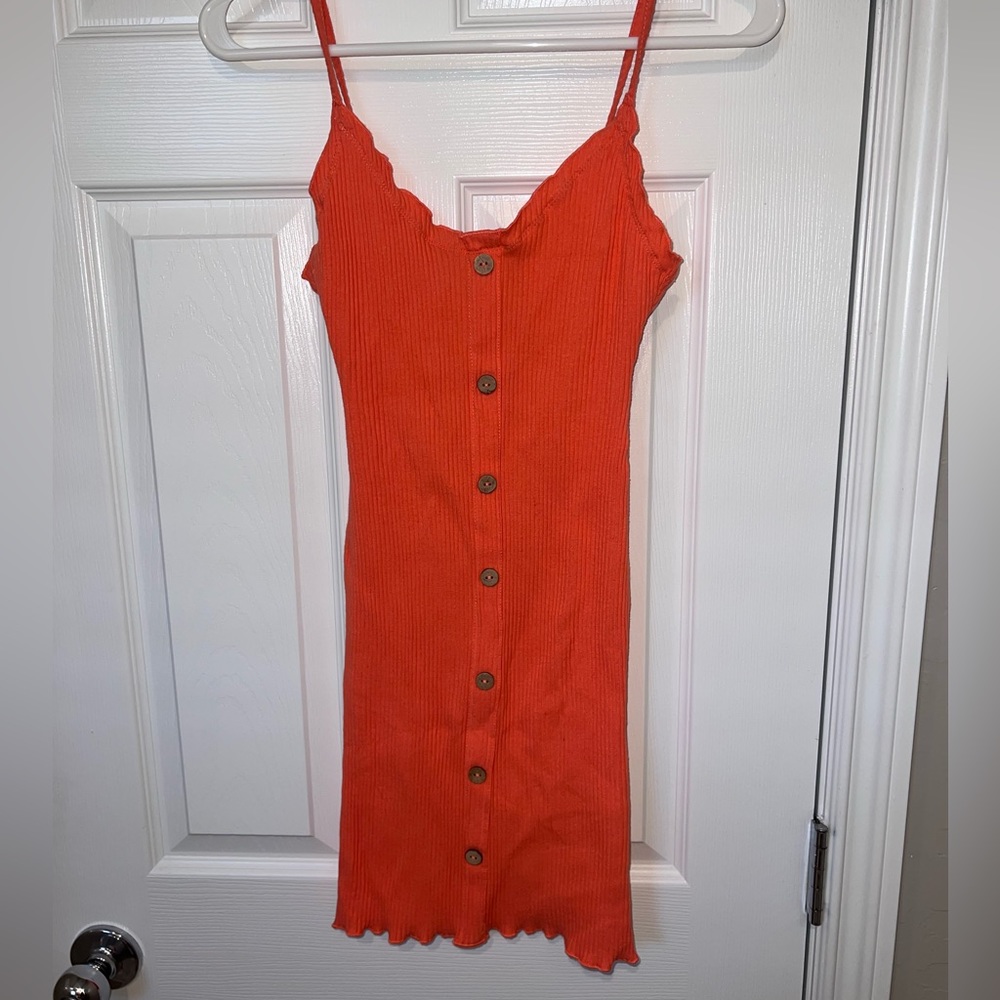 peachy skin tight dress with brown buttons